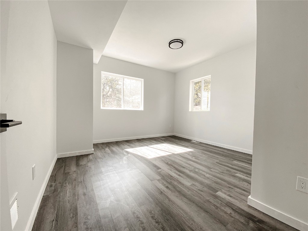 344 Redhill Road Fairplay, CO 80440 - Photo 9 of 34 an empty room with wooden floor and windows