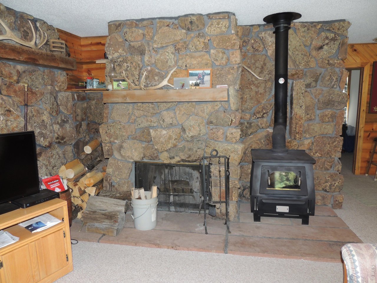 2300 Red Ashby Road Livermore, CO 80536 - Photo 11 of 32 Stone wood fireplace plus convection wood stove