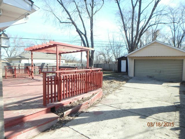 15231 Millard Avenue Midlothian, IL 60445 - Photo 14 of 15 a view of a backyard with a large tree