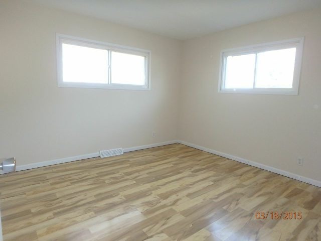 15231 Millard Avenue Midlothian, IL 60445 - Photo 5 of 15 an empty room with wooden floor and windows