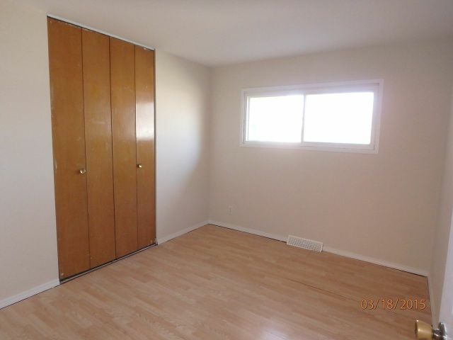 15231 Millard Avenue Midlothian, IL 60445 - Photo 9 of 15 an empty room with wooden floor and windows