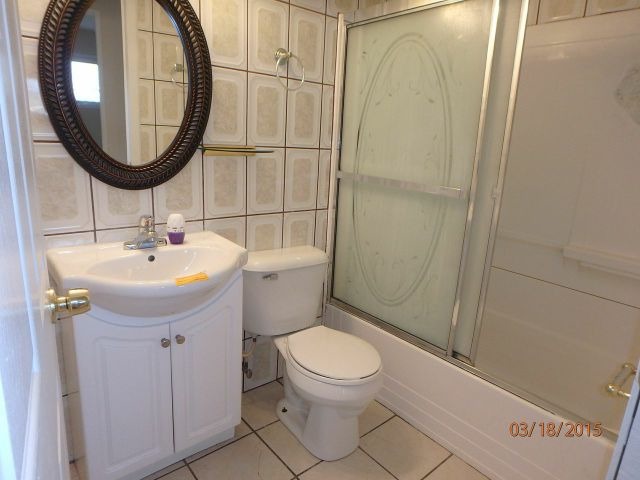 15231 Millard Avenue Midlothian, IL 60445 - Photo 10 of 15 a bathroom with a sink toilet and a mirror