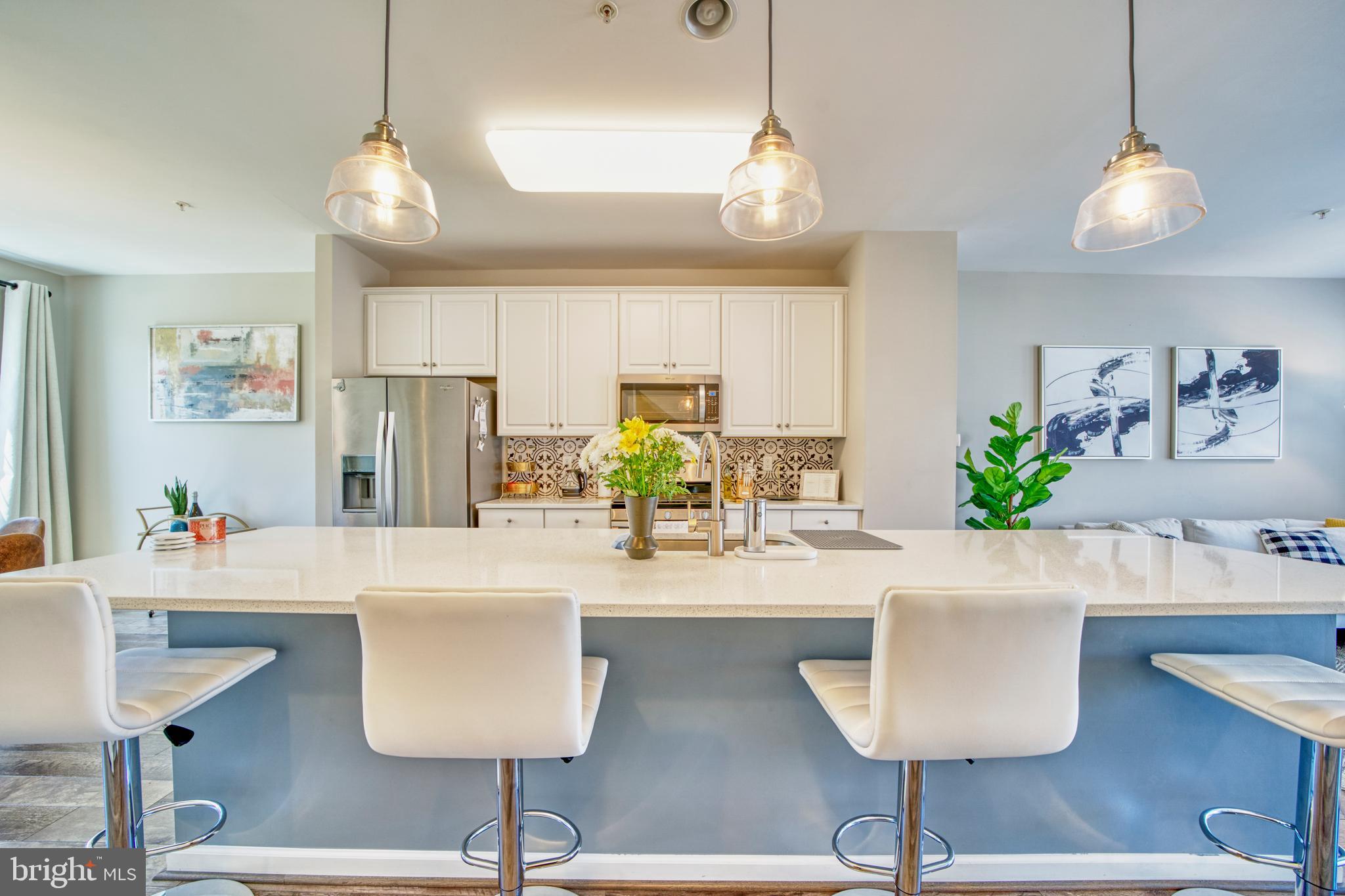 a kitchen with stainless steel appliances granite countertop a table and chairs