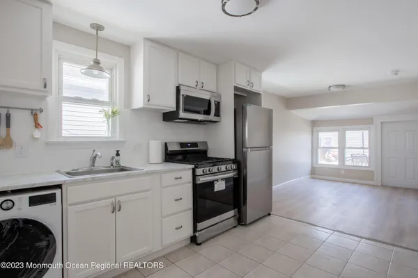 a kitchen with stainless steel appliances a stove sink and microwave