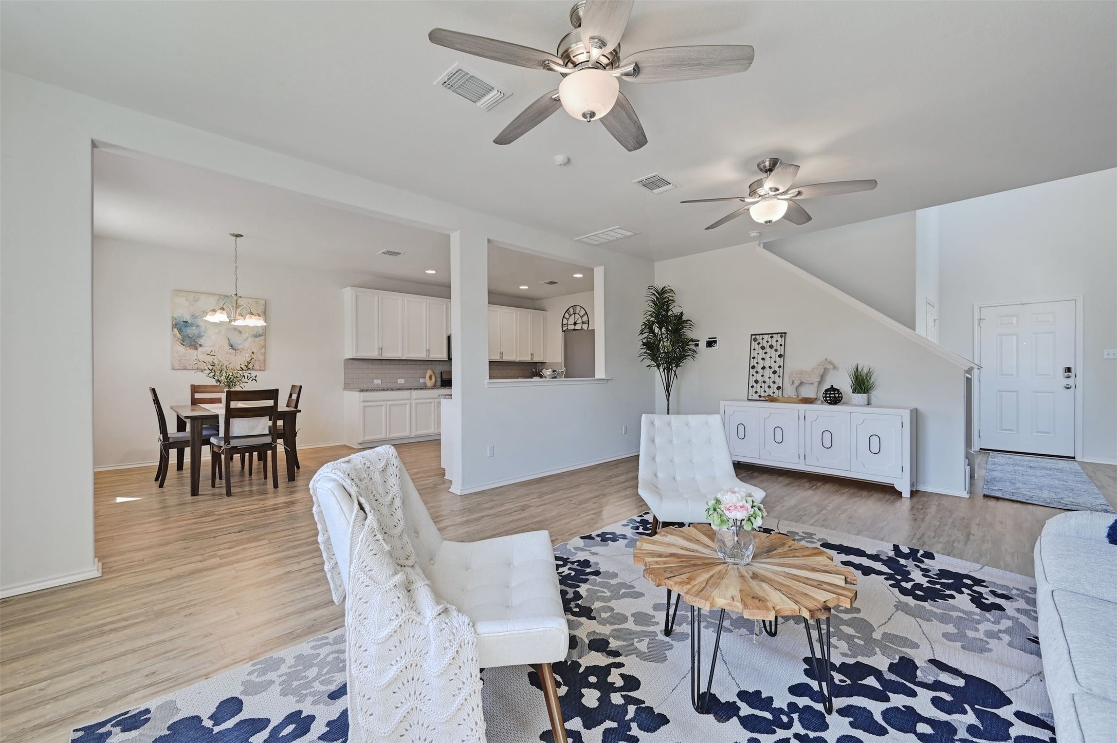 959 Pepperbark Loop Buda, TX 78610 - Photo 1 of 1 The living room seamlessly connects with the eat-in kitchen, creating an open-concept space that fosters connection and convenience for both daily living and entertaining.
