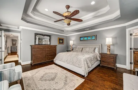 a bedroom with a bed and ceiling fan