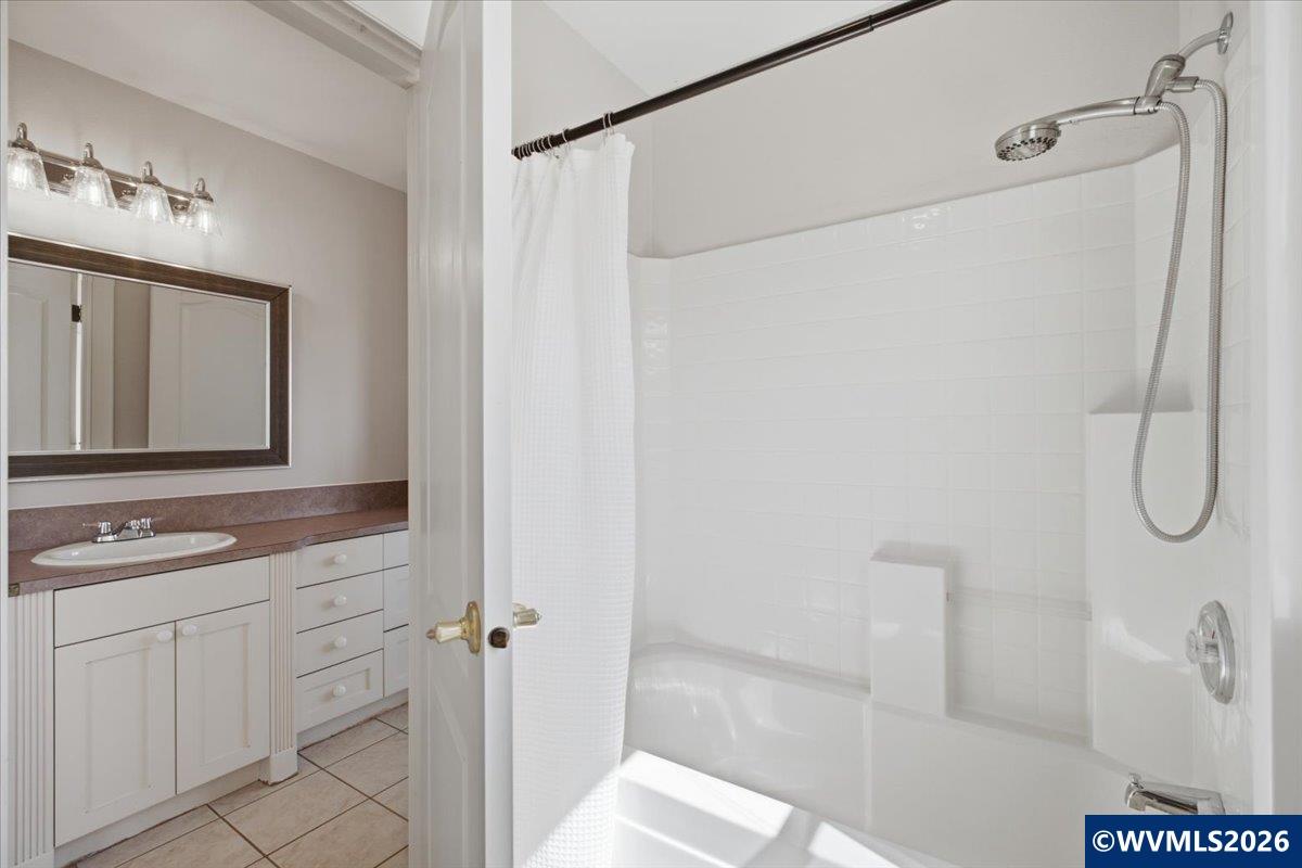 1492 Northwest Penny Lane Albany, OR 97321 - Photo 35 of 50 a bathroom with a granite countertop sink a mirror and shower