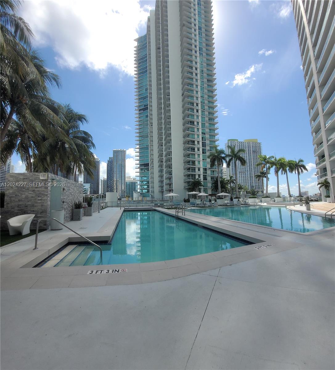90 Southwest 3rd Street, Unit 2208 Miami, FL 33130 - Photo 32 of 56 a view of a swimming pool with outdoor seating
