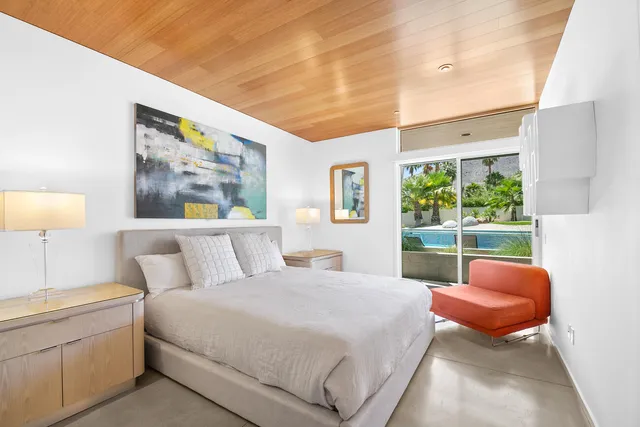 a bedroom with a bed and a television