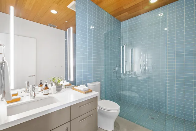 a view of patio with couches and table and chairs under an umbrella