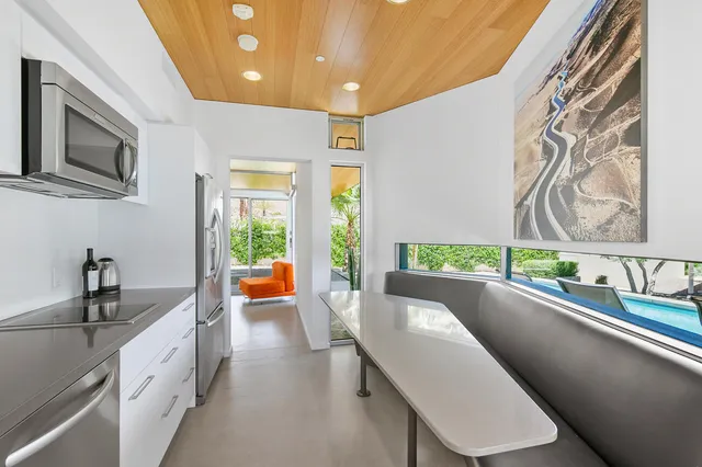 a view of a swimming pool with a patio and a garden