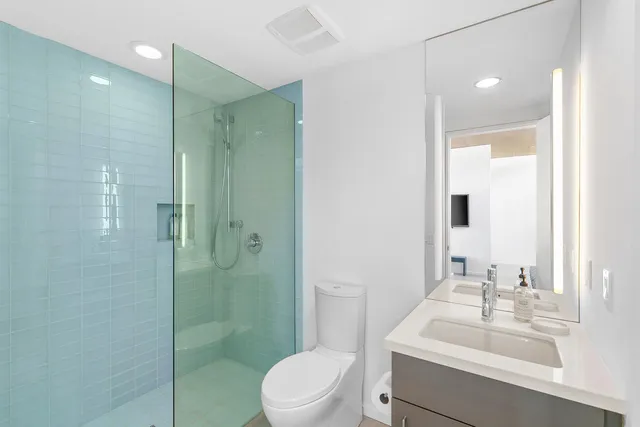 a kitchen with white cabinets and sink