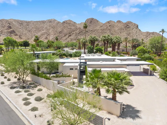 a kitchen with stainless steel appliances kitchen island granite countertop a table and chairs