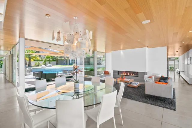a living room with furniture a rug and a large window