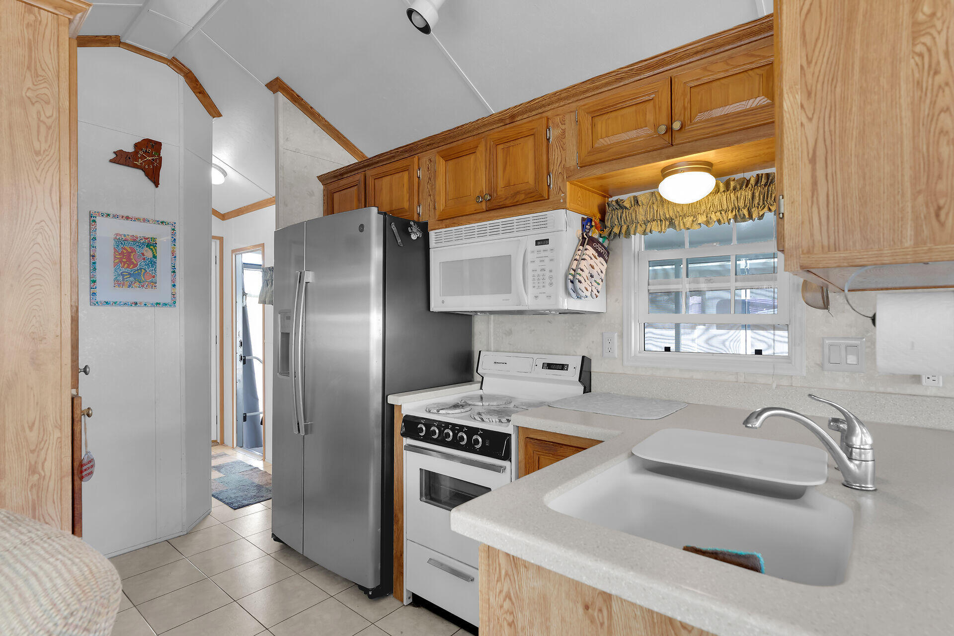 325 Calusa Street, Unit 213 Key Largo, FL 33037 - Photo 15 of 60 a kitchen that has a sink a stove and a refrigerator