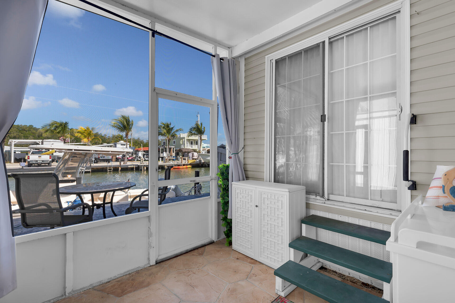 325 Calusa Street, Unit 213 Key Largo, FL 33037 - Photo 24 of 60 a room with lots of wooden furniture and a window