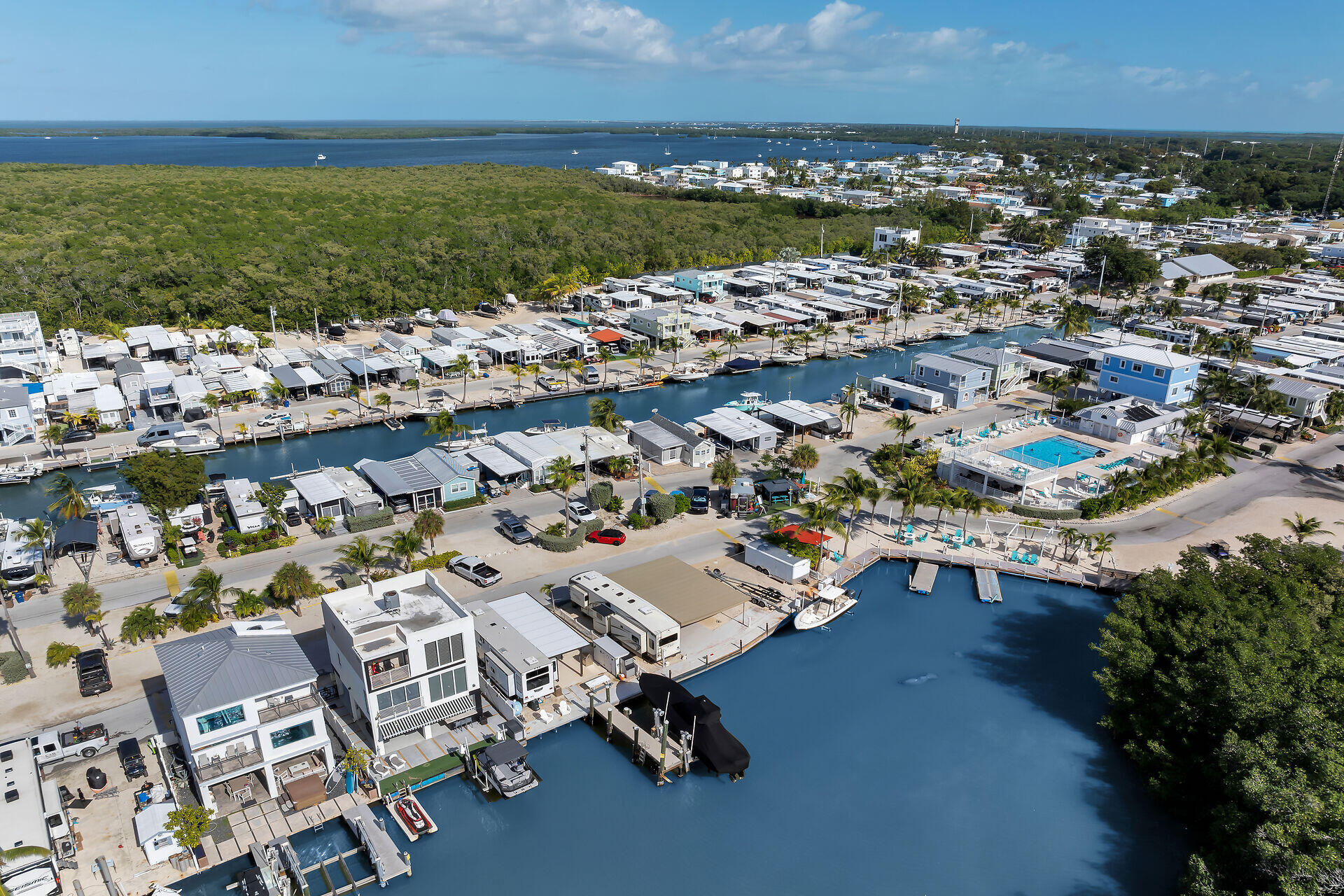 325 Calusa Street, Unit 213 Key Largo, FL 33037 - Photo 28 of 60 an aerial view of residential building with outdoor space lake view and trees all around