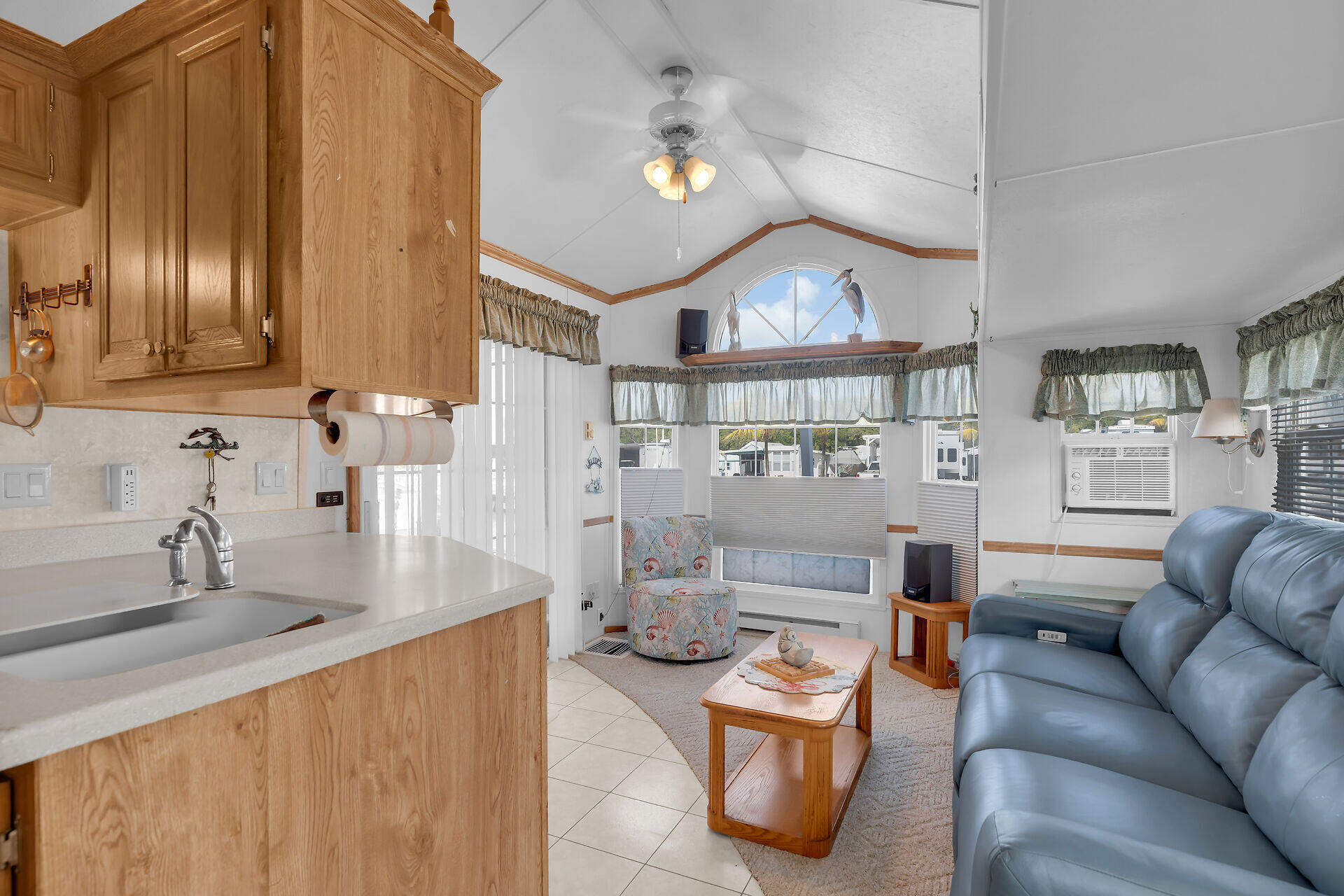 325 Calusa Street, Unit 213 Key Largo, FL 33037 - Photo 8 of 60 a living room with furniture a fireplace and a chandelier