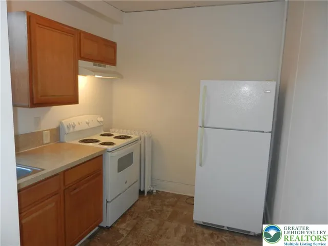 a kitchen with a sink and a refrigerator