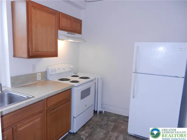 a kitchen with a sink and a refrigerator
