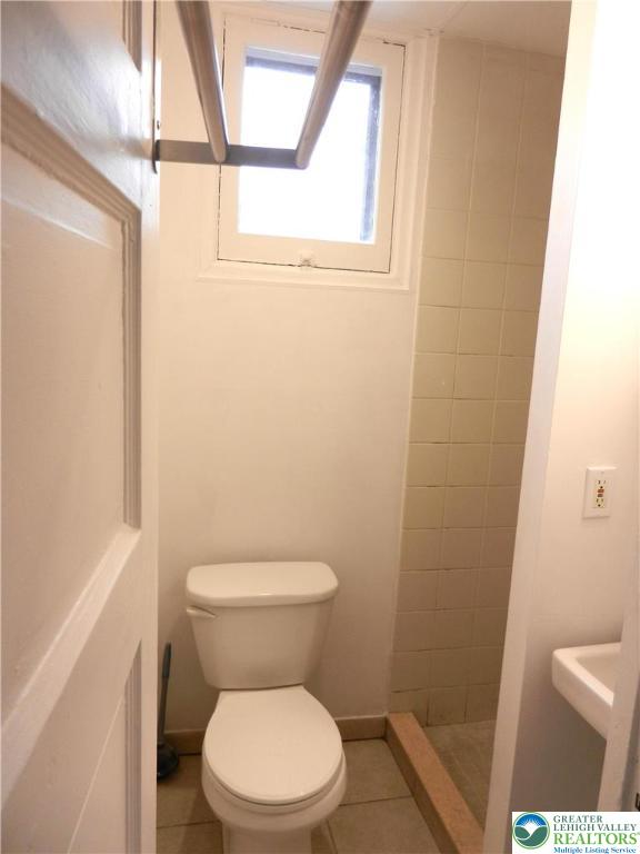 1428 Center Street, Unit 1 Bethlehem, PA 18018 - Photo 7 of 9 a white toilet sitting next to a small window