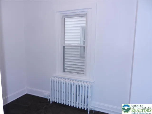 a view of a bedroom with wooden floor