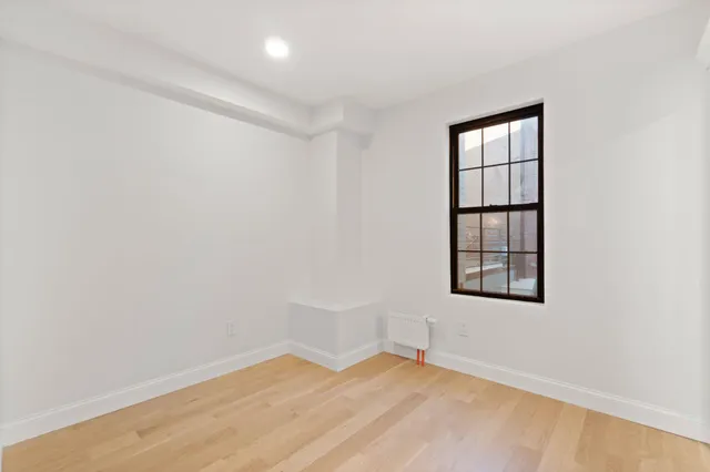 an empty room with windows and closet