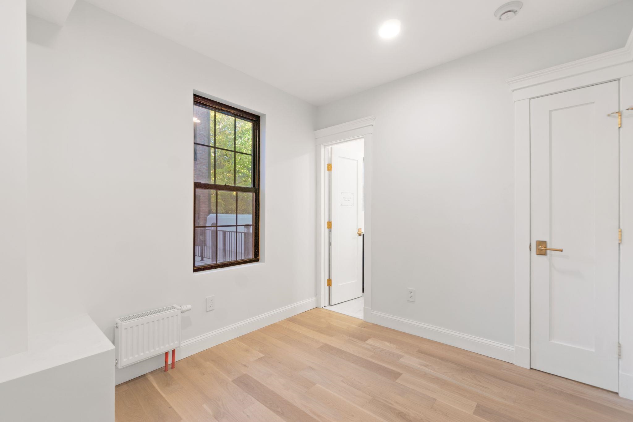 82 Colgate Street, Unit 1 Jersey City, NJ 07302 - Photo 6 of 13 an empty room with windows