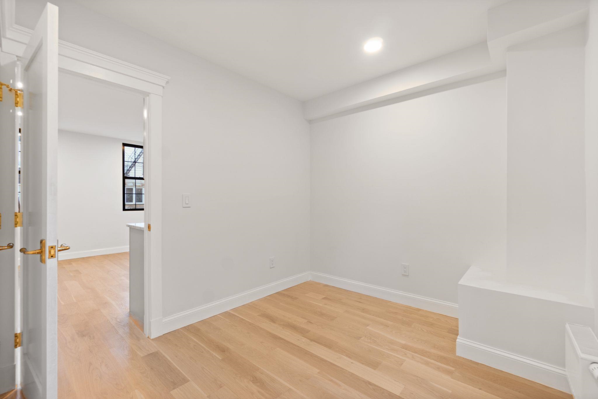 82 Colgate Street, Unit 1 Jersey City, NJ 07302 - Photo 8 of 13 wooden floor in an empty room