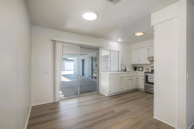 a kitchen with refrigerator and cabinets
