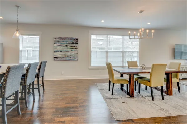 a dining room with furniture window and wooden floor
