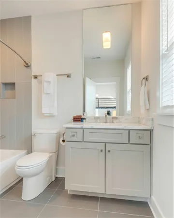 a bathroom with a sink toilet and mirror