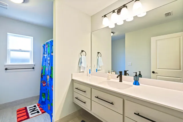 a bathroom with a tub sink toilet and shower