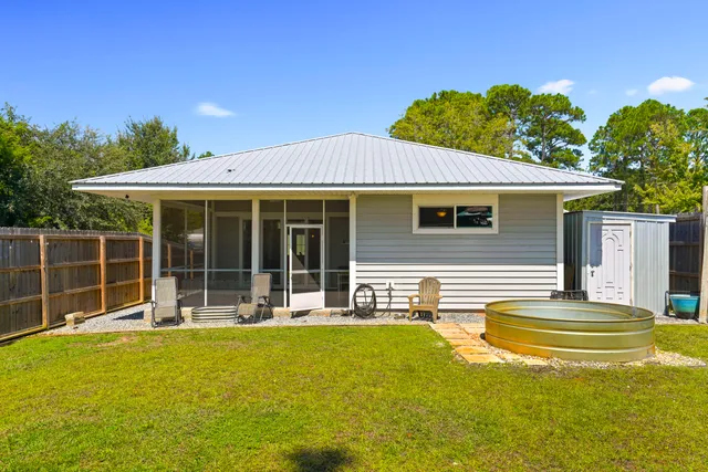 an aerial view of residential houses with outdoor space and trees all around