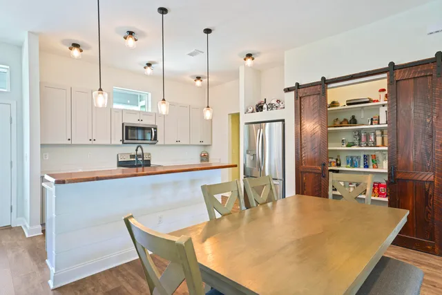 a kitchen with stainless steel appliances granite countertop a sink a stove and a refrigerator