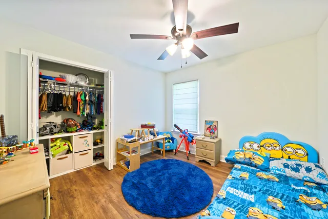 a bedroom with a bed and wooden floor