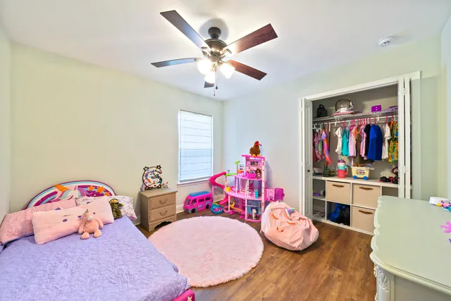 a bedroom with two beds and a chandelier