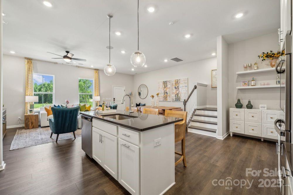 8665 Miles Gap Road Indian Land, SC 29707 - Photo 12 of 31 a kitchen with stainless steel appliances kitchen island granite countertop a sink and cabinets