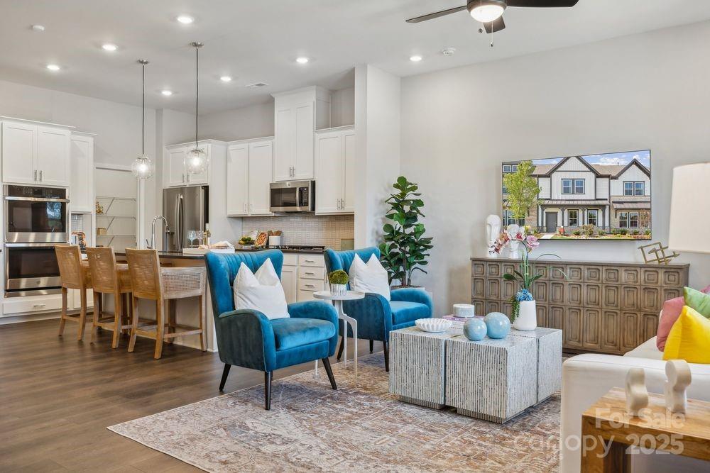 8665 Miles Gap Road Indian Land, SC 29707 - Photo 6 of 31 a living room with furniture kitchen view and a potted plant