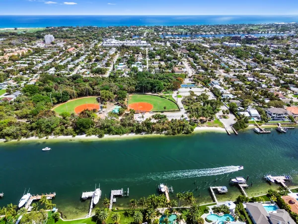 an aerial view of a houses with a lake