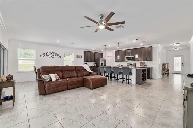 a kitchen with granite countertop stainless steel appliances a stove a sink and a microwave