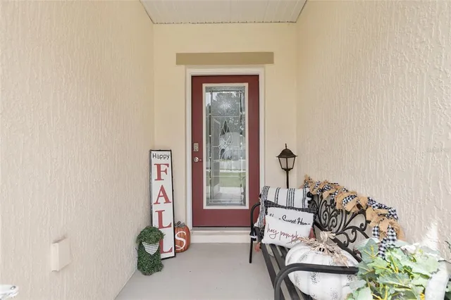 a living room with furniture a flat screen tv and a large window