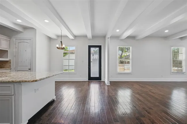 a view of a kitchen cabinets wooden floor and a window