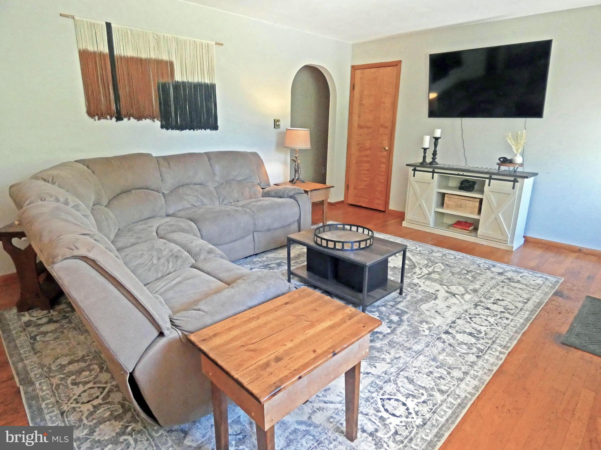 271 Fort Mott Road Pennsville, NJ 08070 - Photo 15 of 45 a living room with furniture and a flat screen tv
