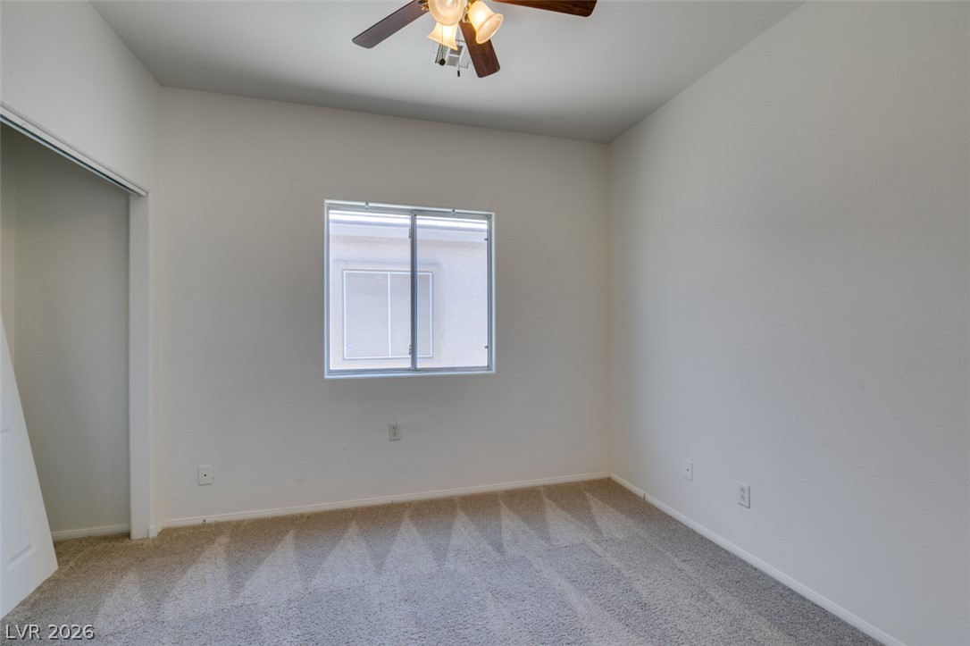 5150 Riverside Run Court North Las Vegas, NV 89081 - Photo 35 of 50 Well-lit room provides a peaceful retreat, with a ceiling fan for comfort.