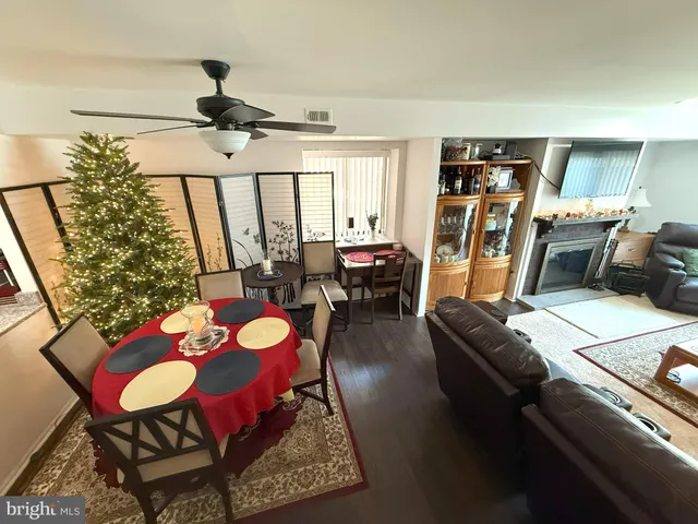 a living room with furniture and kitchen view