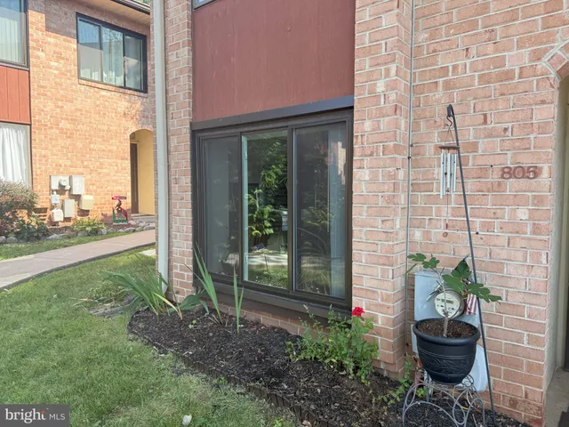 a view of a backyard with table and chairs potted plants