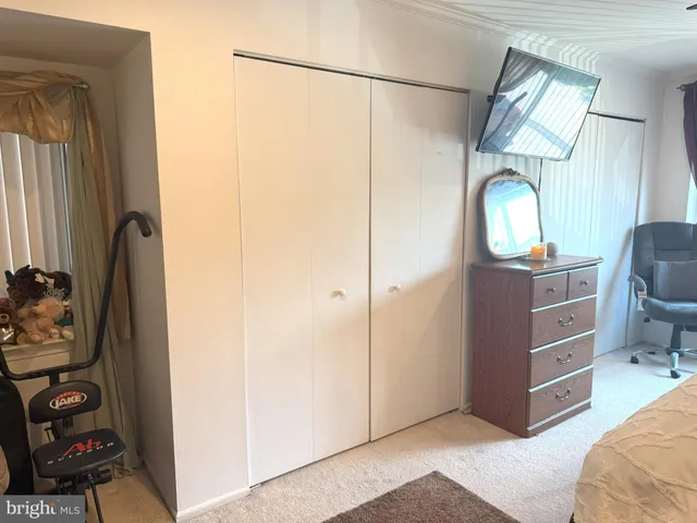a view of a livingroom with furniture and a mirror