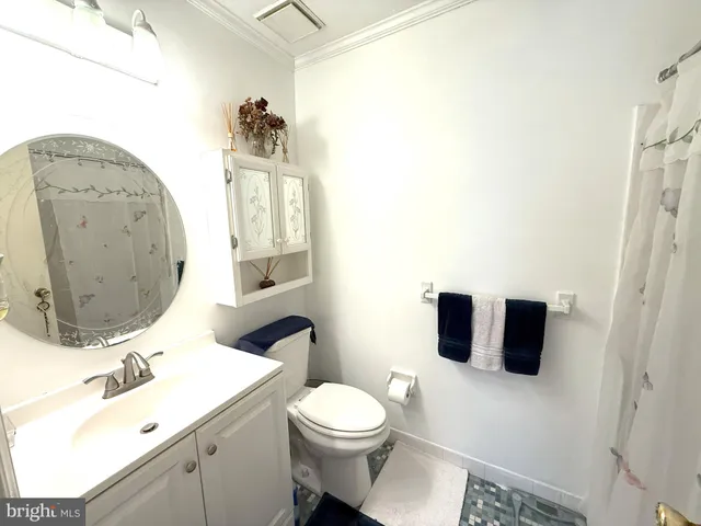 a bathroom with a sink mirror vanity and toilet