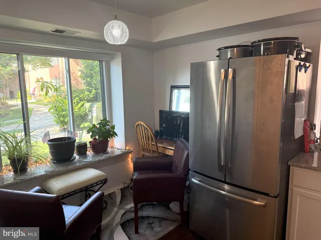 a view of a livingroom with furniture and a potted plant